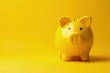 Yellow piggy bank, savings and finance concept, yellow background.