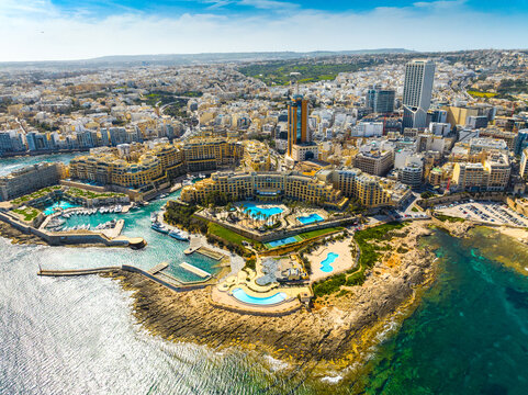 Landscape of f St. Julian's city, high buildings. Day. Maltese island, Mediterranean sea