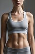 © Eugene - body of a woman doing fitness. in a sports top.