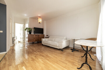 Wall Mural - Homely living room with classic wooden furniture, marble table with wrought iron foot and a white leather sofa