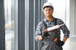 © Serhii - Workman in overalls installing or adjusting plastic windows