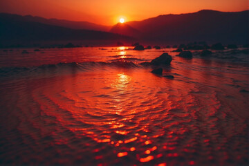 Wall Mural - Sun Setting Over Body of Water