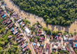 © Sony Herdiana - Residential center on the edge of a river and forest in a rural area, on the edge of a cross-regional road, in East Kotawaringin Regency, Central Kalimantan, Indonesia, seen from an aerial view.