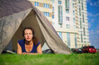 © Pavel Losevsky - Beautiful woman with closed eyes in tent near buildings at sunny day