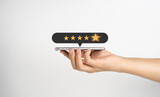 Fototapeta Mapy - Hand holding smartphone show five golden stars for client the best experience after use product and get service , customer feedback evaluation and satisfaction concept.
