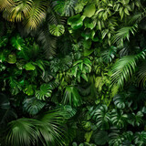 Fototapeta Sypialnia - Lush green tropical leaves filling the frame with various shades and textures