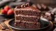 Chocolate cake slice on a plate with layers of frosting, a dessert lover's delight.