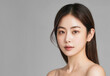 © NoonBusin - Studio shot of a Beautiful asian idol girl with healthy skin looking at the camera. Natural makeup of a beautiful model with copy space. Cosmetic concept.
