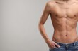 © New Africa - Shirtless man with slim body on grey background, closeup. Space for text
