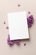 Invitation card template with flowers composition, blank card mockup, top view