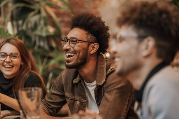 Colleagues in a meeting laugh together at the office