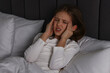 © New Africa - Little girl suffering from headache in bed at night