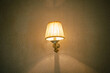© fthnl - Yellow decorative lampshade with metal body on old dotted wallpaper