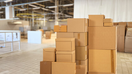 Poster - Cardboard boxes in building under construction. Stack of parcels without label. Boxes inside future office building. Concept of moving commercial company. Office changing company boxes