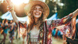 A woman wearing a straw hat and a colorful outfit is smiling and waving at the camera. She is surrounded by a crowd of people, and there are several musical instruments in the background festival