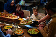 © .shock - In this captivating aerial view, delicious food adorned with Ramadan decorations, including dates and meat, awaits the arrival of an European Islamic family, promising a festive and flavorful iftar