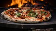 A closeup of a rustic, woodfired pizza with charred edges