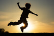 Silhouette boy jumping at sunset. Generative AI