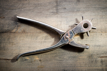 Leather hole punch tool on a workbench