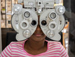 Optometrist examining eyesight African girl