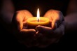 © top images - A person is holding a candle in their hand