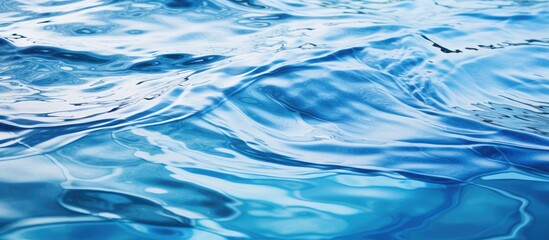 Canvas Print - A stunning closeup of electric blue water surface with mesmerizing wind waves creating a beautiful pattern, resembling a painting in the ocean