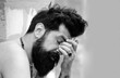 © Volodymyr - Hangover attacked unexpectedly. Morning after few drinks can be harsh sometimes. Overworked. Bearded man. Male barber fashion care. Tired man feeling overworked.