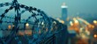 A closeup of the top edge of an industrial fence with barbed wire with a blurred cityscape in the background Generative AI