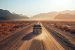 A rugged truck speeds down a dusty desert road under the scorching sun.
