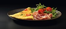 Frittata With Prosciutto, Pesto Sauce, Arugula And Paprika On A Black Plate. Isolated Black Background