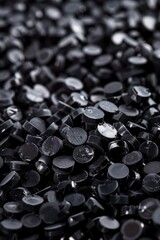 Aufkleber - A close-up view of a pile of black buttons. Suitable for fashion or crafting projects.