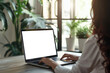 © Behcet - Woman working on her laptop in a home office remote work, mockup
