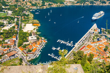 Wall Mural - Aerial view of marina in Kotor bay and old town from Lovcen Mountain, Montenegro. Adriatic fjord with yachts and cruise ship in summer day. Travel destination