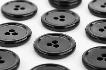 Poster - A bunch of black buttons on a white surface. Perfect for fashion or sewing projects.