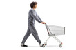 © Ljupco Smokovski - Man in pajamas pushing an empty shopping cart