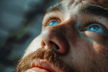 Sticker - Close up of a man with striking blue eyes, perfect for eye care or beauty concepts.