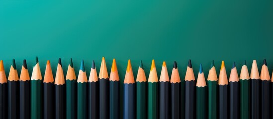 Poster - A symmetrical row of writing implements in various tints and shades, resembling a cone of colorful flames, lined up on a blue background