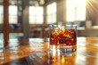 © MK studio - a glass of whiskey with ice stands on a wooden table in a home office
