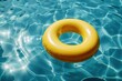 Yellow inflatable ring floating on blue water in swimming pool summer vacation concept Generative AI