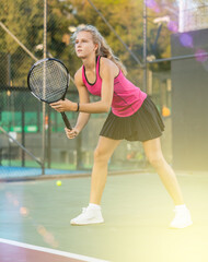 Wall Mural - Sports girl is ready to repel an attack while playing tennis