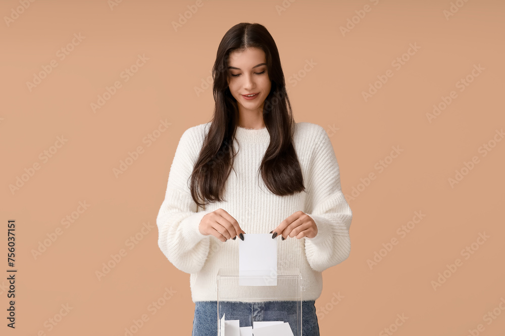 Young woman near ballot box on beige background