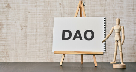 Poster - There is notebook with the word DAO. It is an abbreviation for Decentralized Autonomous Organization as eye-catching image.
