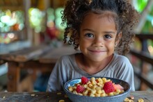 Young Girl Enjoying Cereal At Table