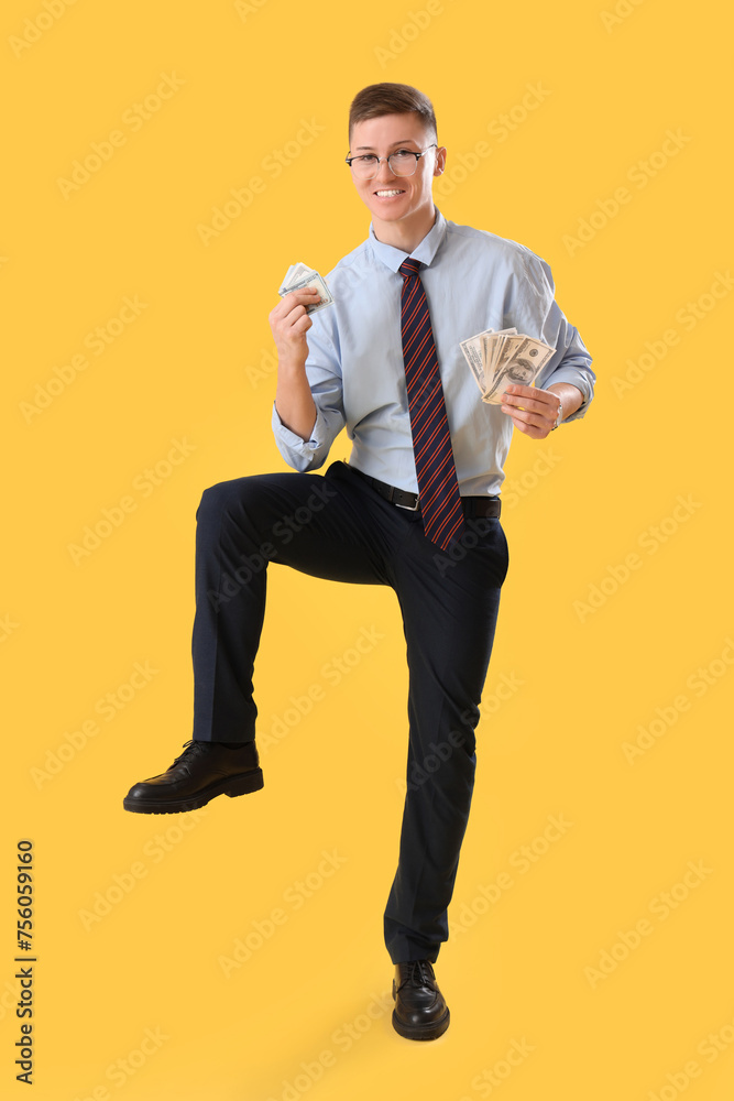 Funny businessman with money on yellow background