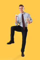 Wall Mural - Funny businessman with money on yellow background