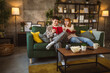 © Miljan Živković - man and woman caucasian adult couple read books at home on sofa bed