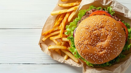 Wall Mural - Classic burger and fries on wooden table, top view with copy space for text placement