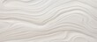 A detailed closeup of a white marble texture resembling waves, with a liquidlike appearance. The pattern is reminiscent of an aeolian landform