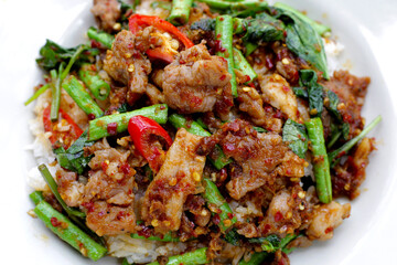 Wall Mural - Rice with spicy stir fried pork and yard long bean with red curry paste. Thai food