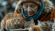 A woman feeds stray cats on the street